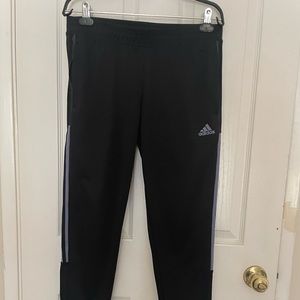 Adidas black with light blue strips.